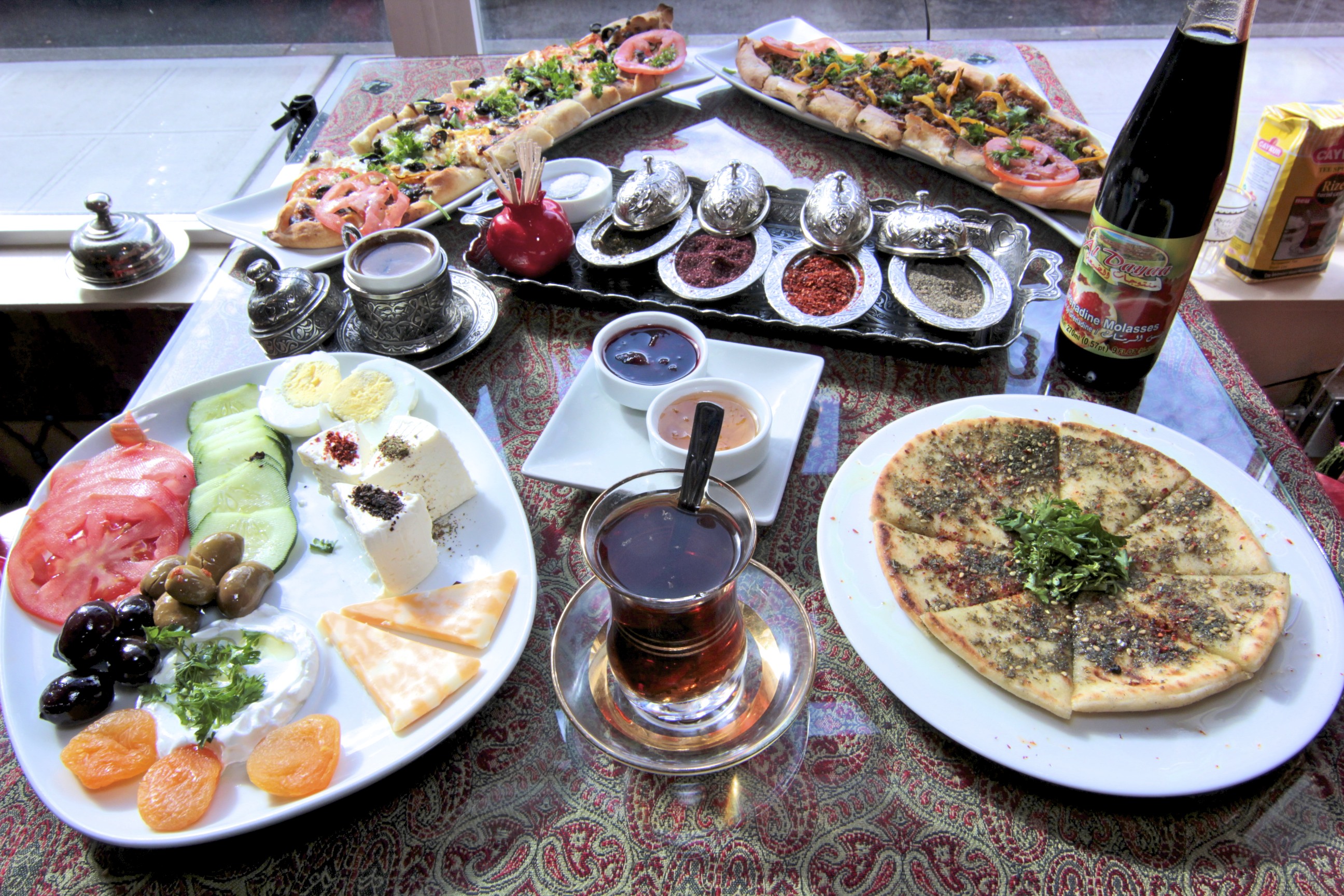 Left: A Turkish breakfast platter at Cafe Turko. Right: Sureyya Gokeri, Cafe Turko’s chef, poses with a Turkish dish.