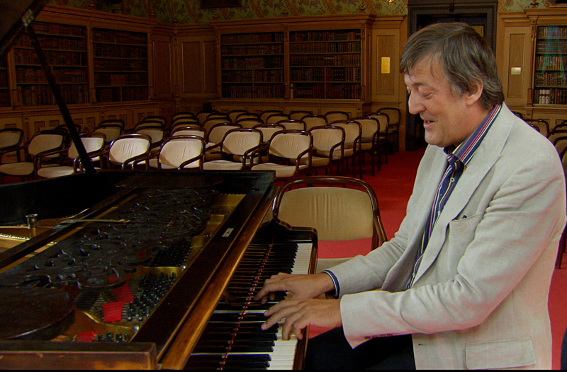 Fry tickles the ivories on Wagner's own piano.