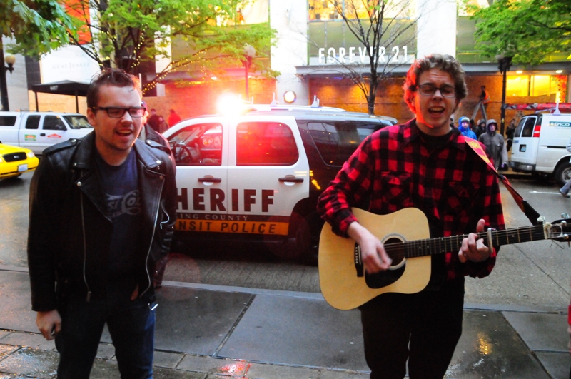 These singers in front of Pacific Place continued their music. They said that when they saw the protestors running toward them, they switched to a Bob Dylan song.