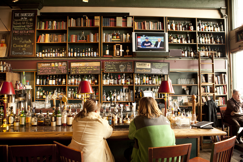 At Bookstore Bar. Whiskies stand between the bartender and her customers. ItaE™s best not to stray too far from brown liquor here.