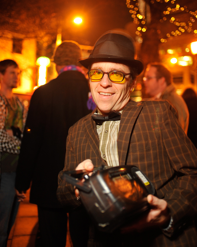 Clad in business attire and wielding boomboxes, hundreds of revelers romped around