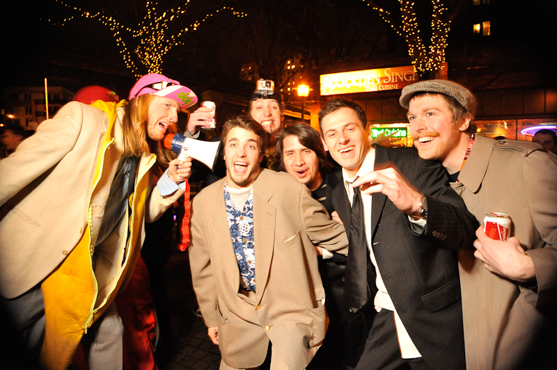 Clad in business attire and wielding boomboxes, hundreds of revelers romped around