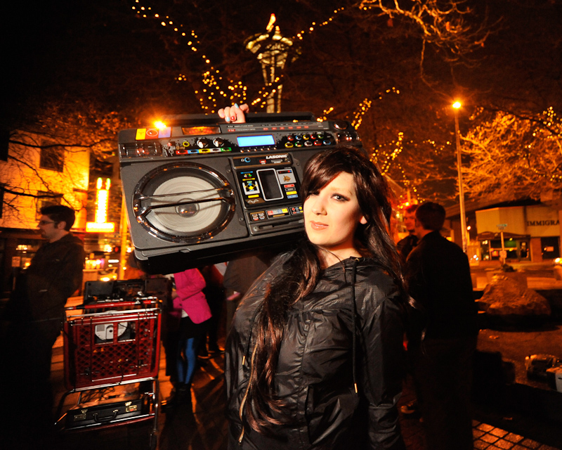 Clad in business attire and wielding boomboxes, hundreds of revelers romped around