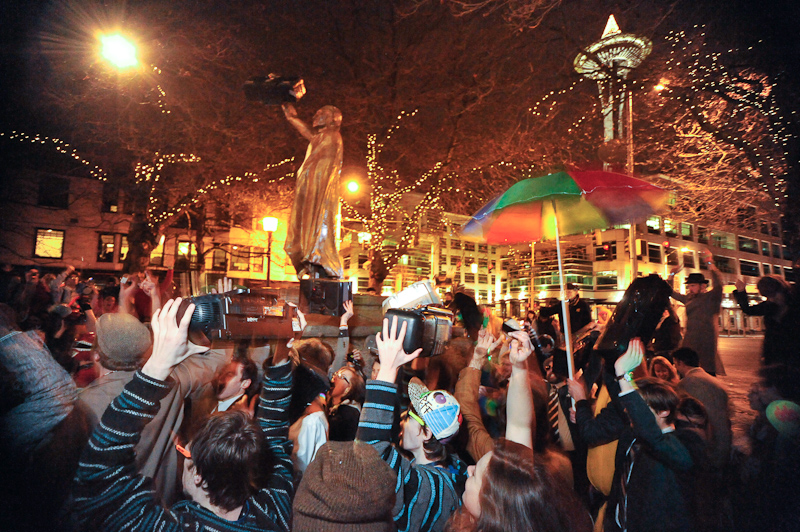 Clad in business attire and wielding boomboxes, hundreds of revelers romped around