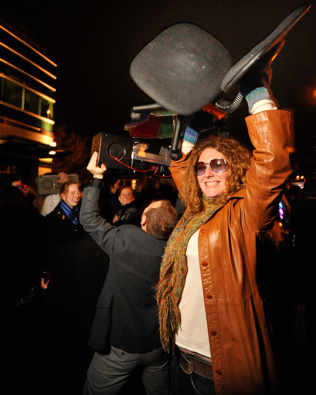 Clad in business attire and wielding boomboxes, hundreds of revelers romped around