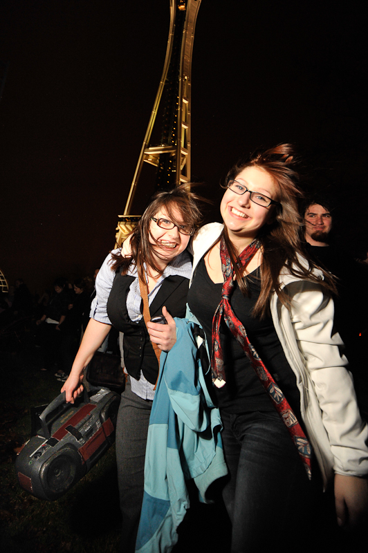 Clad in business attire and wielding boomboxes, hundreds of revelers romped around