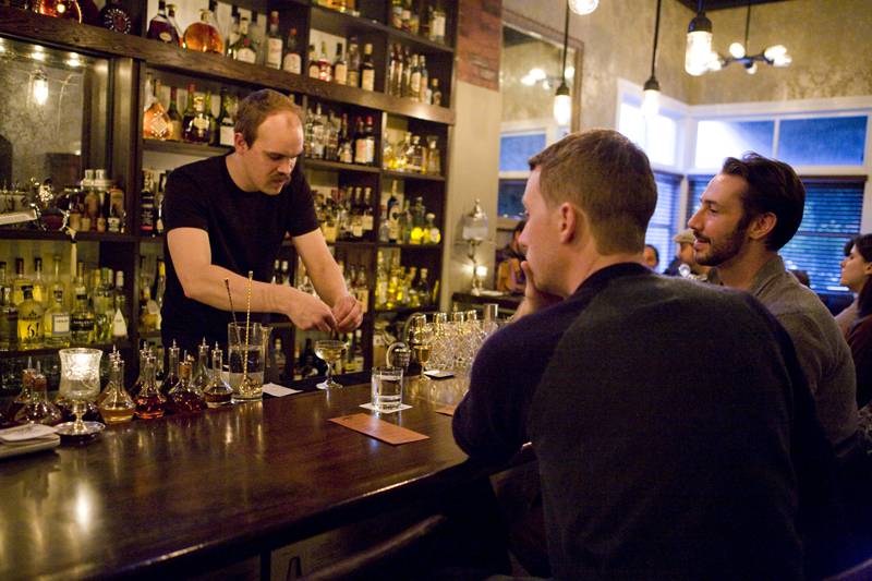 Bartender, Chris, serving drinks made out of the cocktail guide offered to customers.