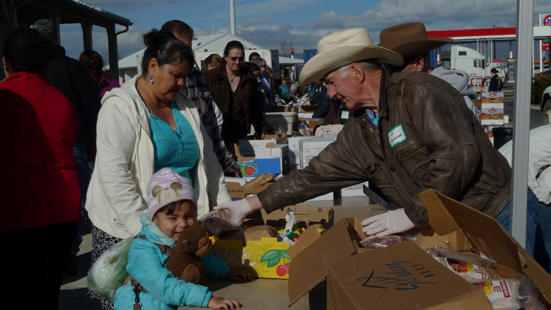 Tomasa, an immigrant from Nayarit, Mexico accepting beef from a Kittitas County cattleman.