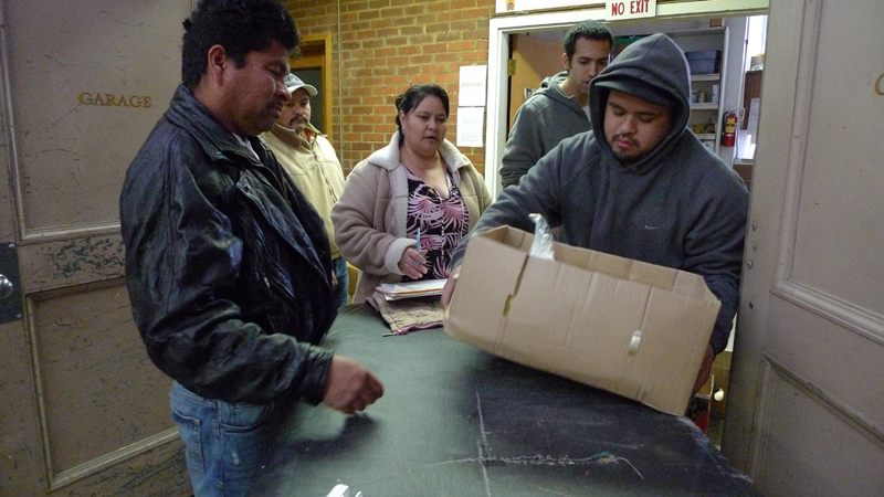 Volunteers distribute food to the needy among EllensburgaE™s Hispanic population at the APOYO food bank on the campus of Central Washington University.