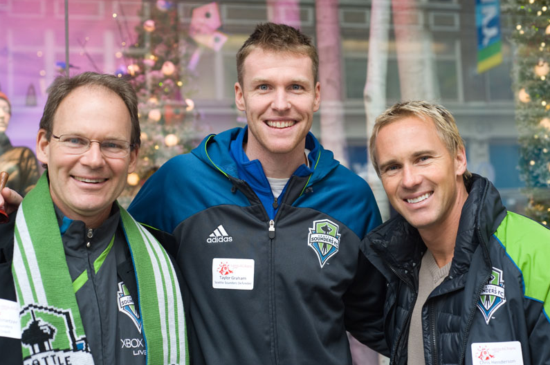 Sounders player Taylor Graham poses with fans at a Salvation Army fundraising event, proving good looks and a good heart sometimes go together.