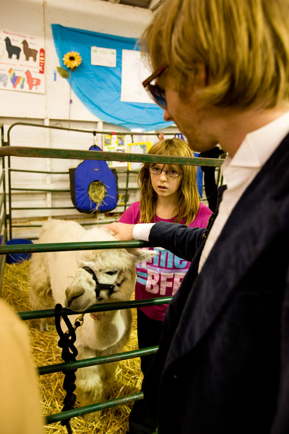 Lead singer Tom Beecham learns the difference between an alpaca and a llama from Zoe and her alpaca Durango.
