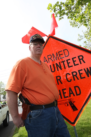 A group from OpenCarry.org pick up trash along their area along Interstate 5 Freeway near Fife as part of the Adopt-A-Highway program on Sunday, May 17, 2009. The group supports the right to carry a firearm . (Kevin P. Casey/Seattle Weekly)