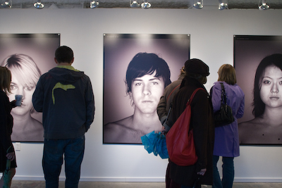Jojo Corvaia's The Human Factor Project attract art walkers at May's First Thursday Art Walk in Pioneer Square.
