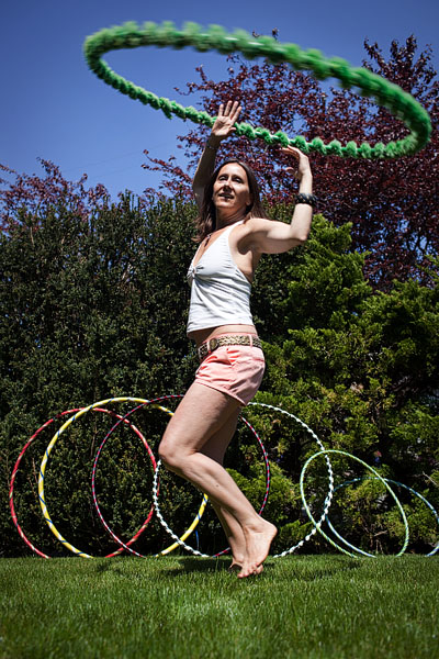 Seattle People visited West Seattle on Garage Sale Day on Saturday May 9. Here, Ms. Merileu shows off her hand decorated hoops for sale and her hula hooping skills.