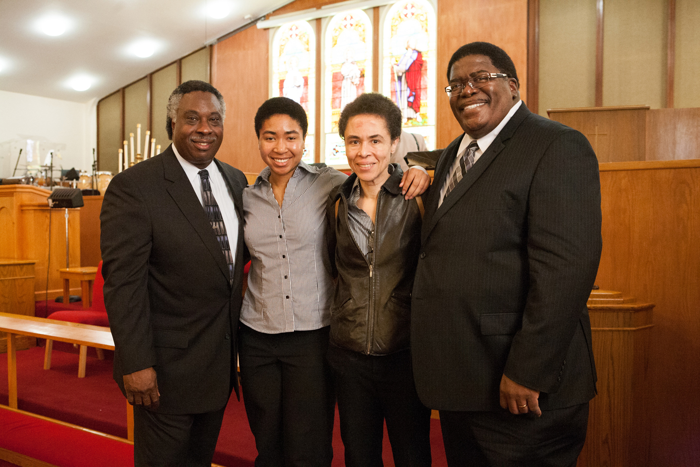 Pastor Carey Anderson of First AME, left, with the Buhl family earlier this month.