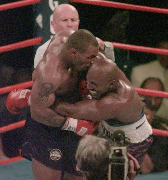 Mike Tyson bites into the ear of Evander Holyfield in the third round of their WBA Heavyweight match Saturday, June 28, 1997, at the MGM Grand in Las Vegas.  (AP Photo/Jack Smith)
