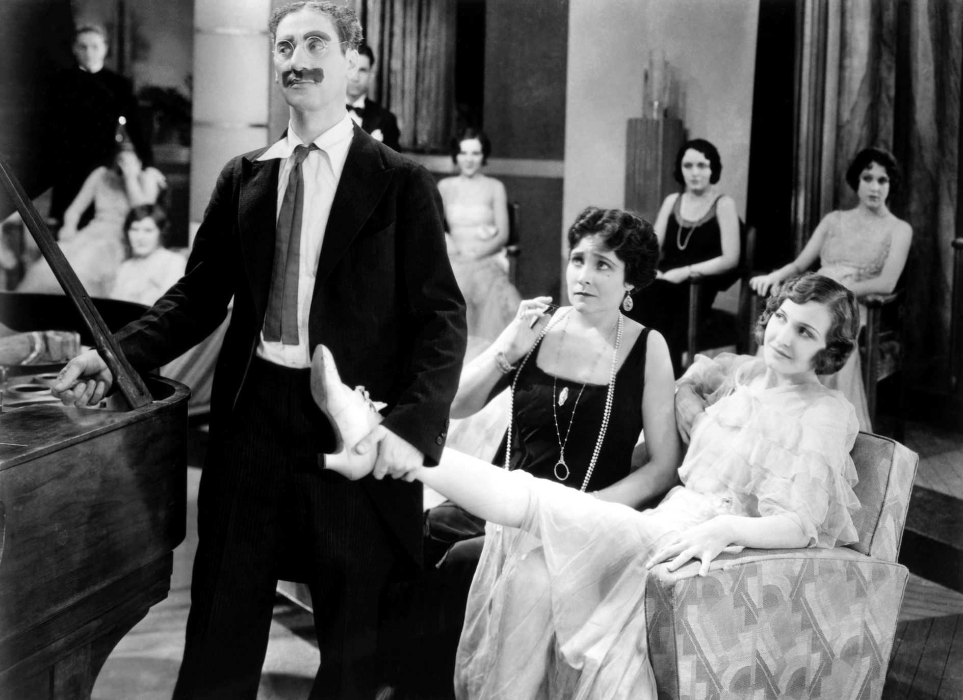 Groucho showssome leg.