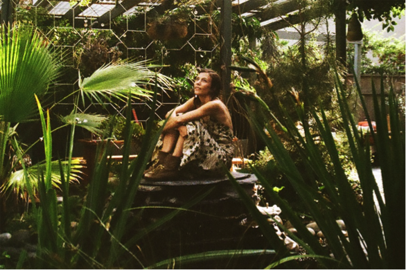 Mileece pondering what sounds might come out of all the green stuff surrounding her.