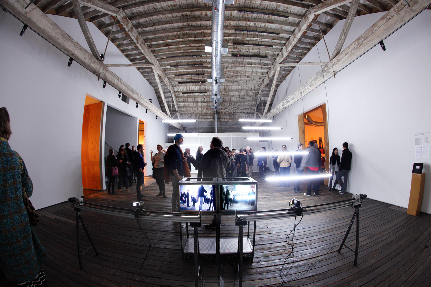 Opening night for Site Machines, with cameras and monitors in the foreground.