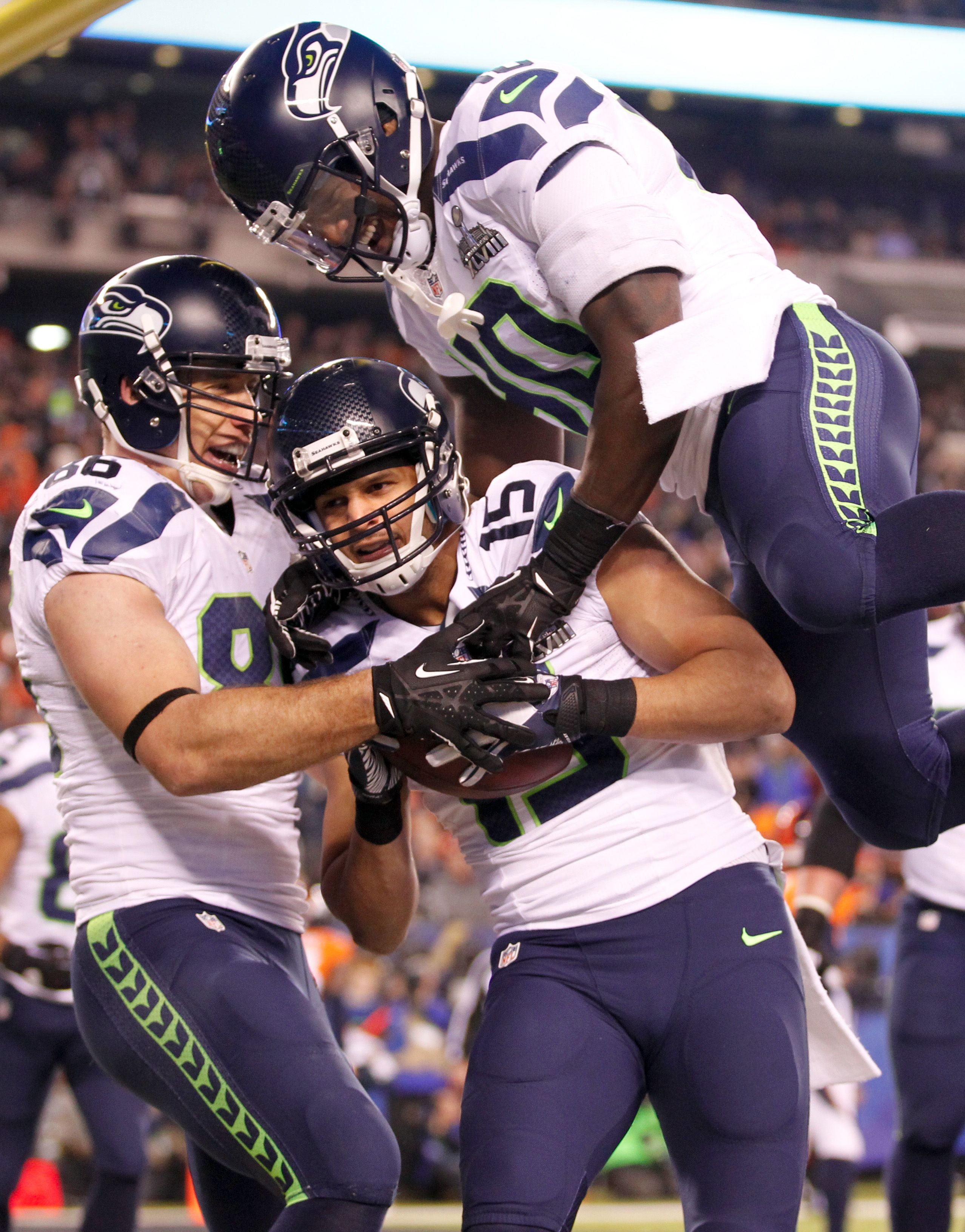 Seahawks wide receiver Jermaine Kearse celebrates his third quarter touchdown reception against the Denver Broncos with Seahawks tight end Zach Miller and Seahawks running back Derrick Coleman in Super Bowl XLVIII at MetLife Stadium. Photo by Jennifer Buchanan of The Daily Herald
