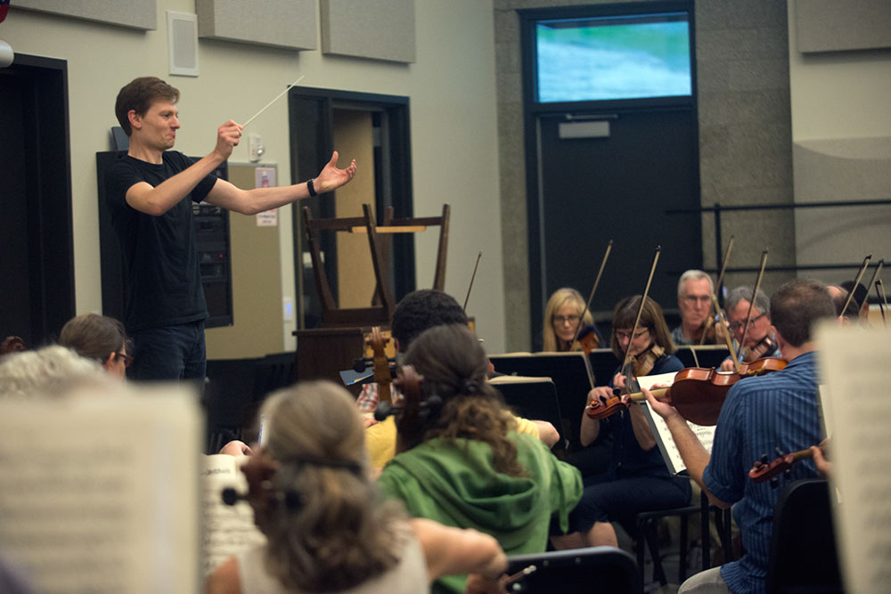 New conductor, Clinton Smith, leads Orchestra Seattle during rehearsal. photo by Morgen Schuler