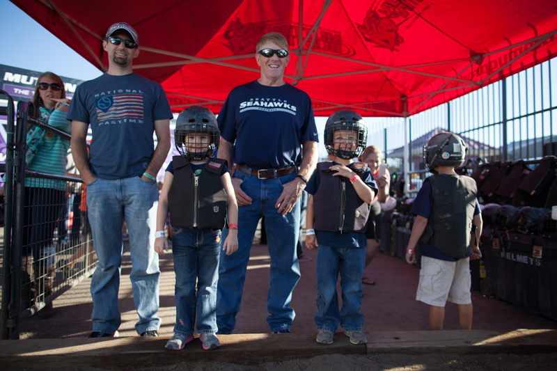 Twins Karli and Grady, 5, pose for a photo with their father, left, and grandfather, right, before their run.