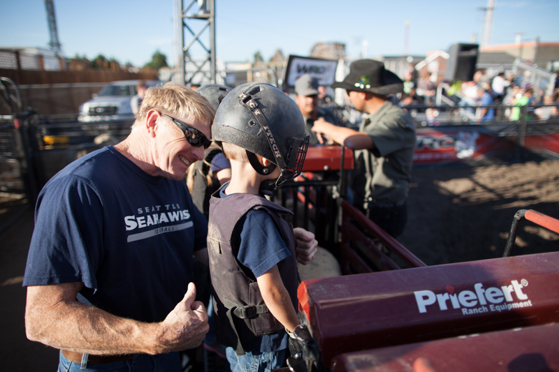Standing on the chute, Grady recieves some last-minute encouragement from his grandfather.