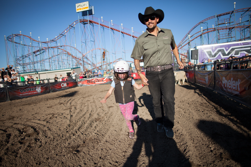 A girl is helped out of the arena by an employee after her run.