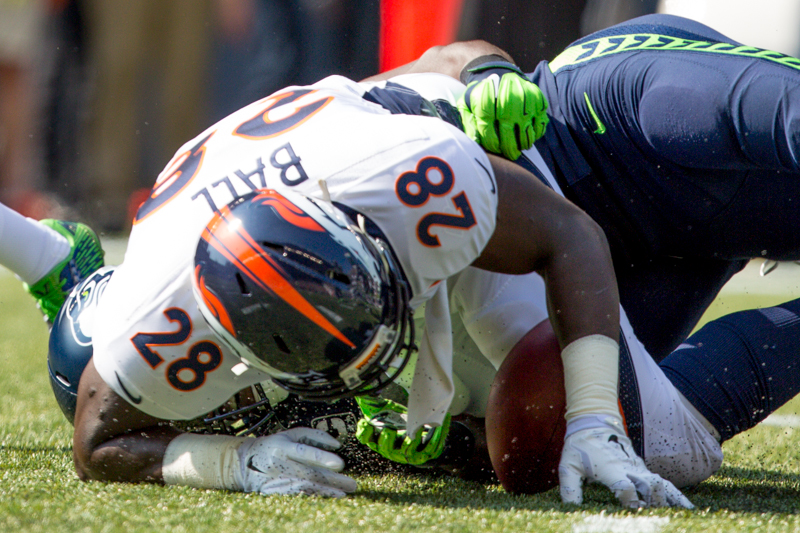 Denver running back Montee Ball fumbles the ball in the first quarter following a hit by Seattle's Kam Chancellor.