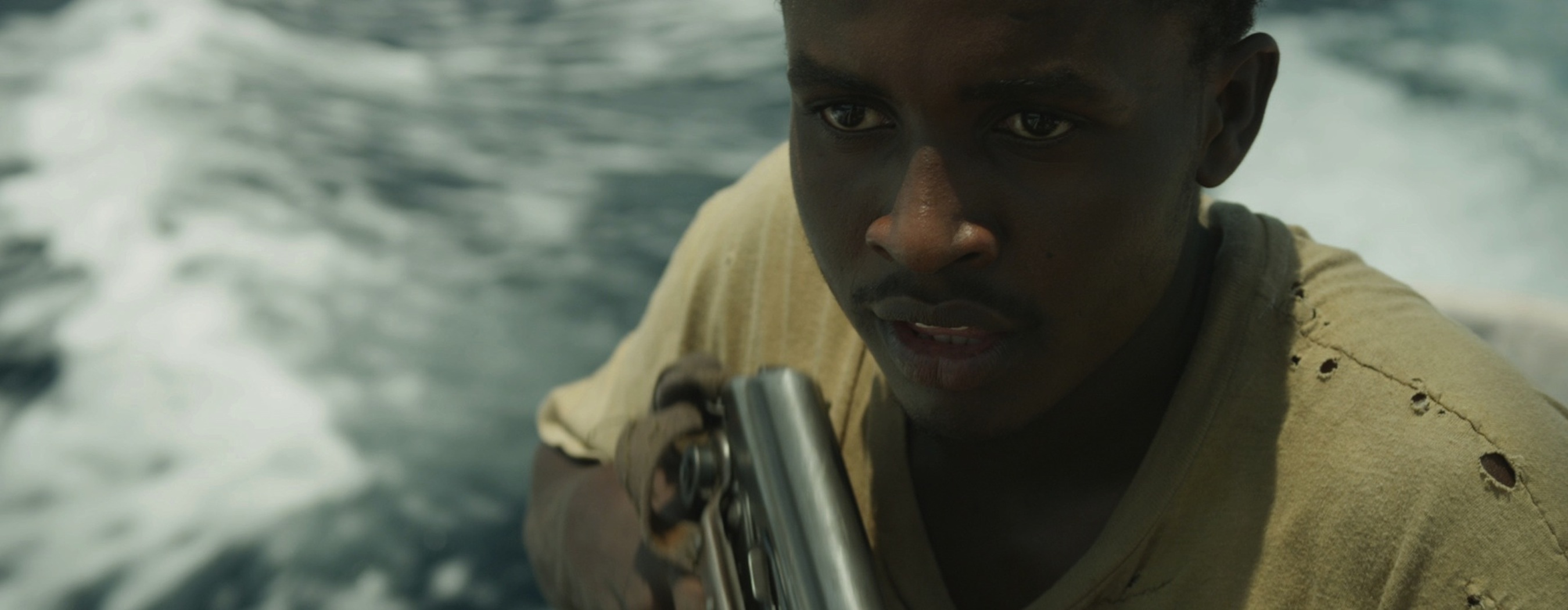 Abdi (Muktar) nervously handles his AK-47.