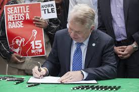 Mayor Ed Murray signs minium wage legislation.