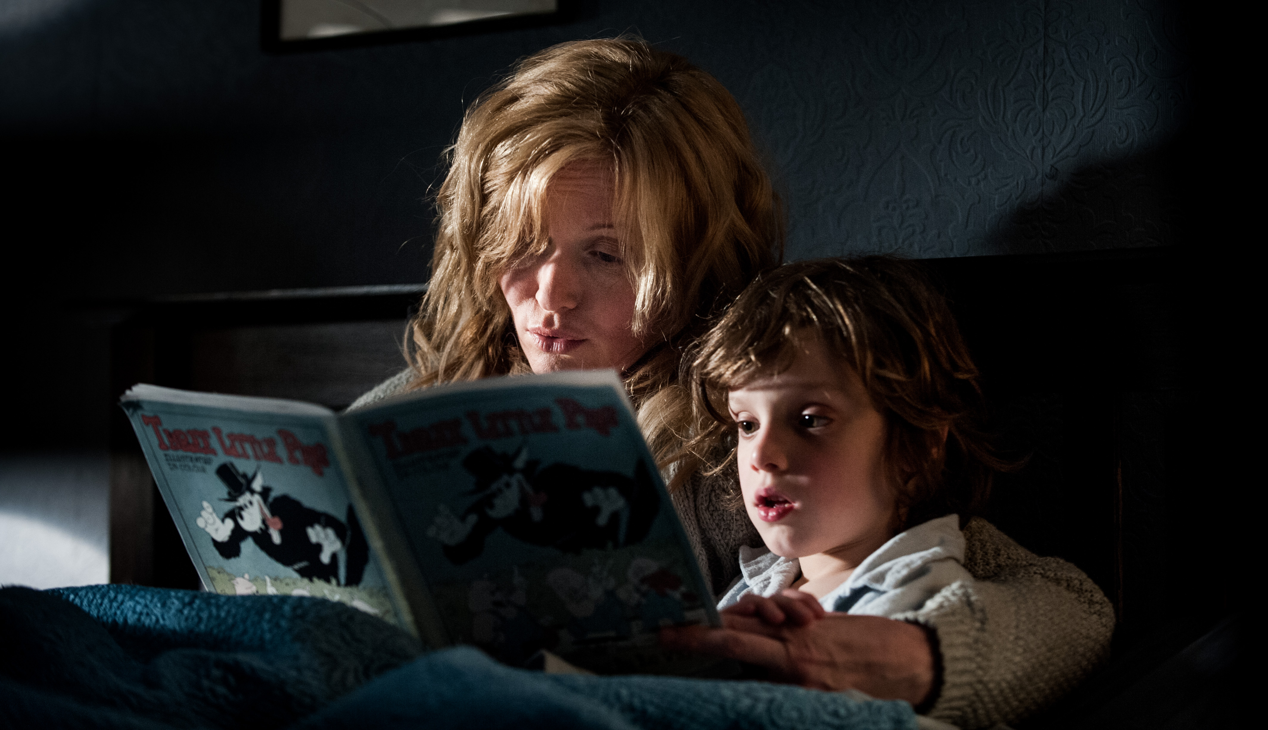 Mother and son (Davis and Wiseman) read before bedtime.