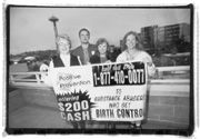The founders of Positive Prevention, including Ella Sonnenberg (far left) and Jennifer Nelson (far right), raise the birth control flag.