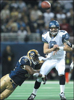 Matt Hasselbeck (8) lets one fly while under pressure.