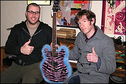 Darrin Wiener, left, and the Vells' Tristan Marcum with the infamous pink pleather guitar.