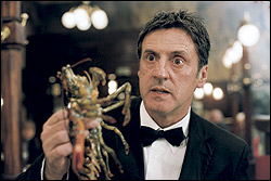 Unable to elicit laughs by any other means, Auteuil resorts to waving a lobster.