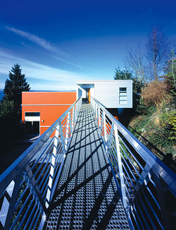 The Mile Post 9 home is accessed by a marina gangplank appropriate to its maritime setting.