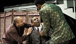 Left to right: Justin Emeka, William Hall Jr., and Jonte Ausler wrestle with Salesman.