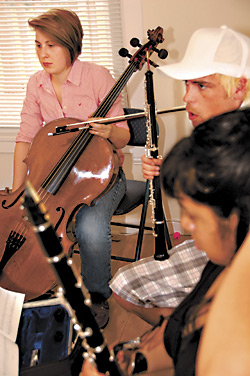 Money-makers? Shawn Meloy (center) and musicians rehearse a piece by Jeremiah Oliver.