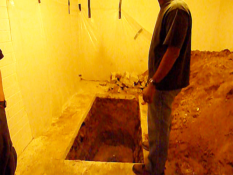 A 32-year-old Latino, taken hostage by two armed men, narrowly escaped getting buried alive inside this makeshift grave his kidnappers dug inside a Phoenix home.