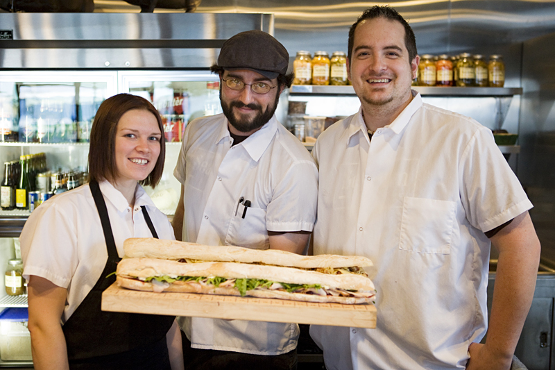 (l-r) Karissa Wood, Jack Spies, and Michael Lopata display Tom Douglas' favorite sandwich.