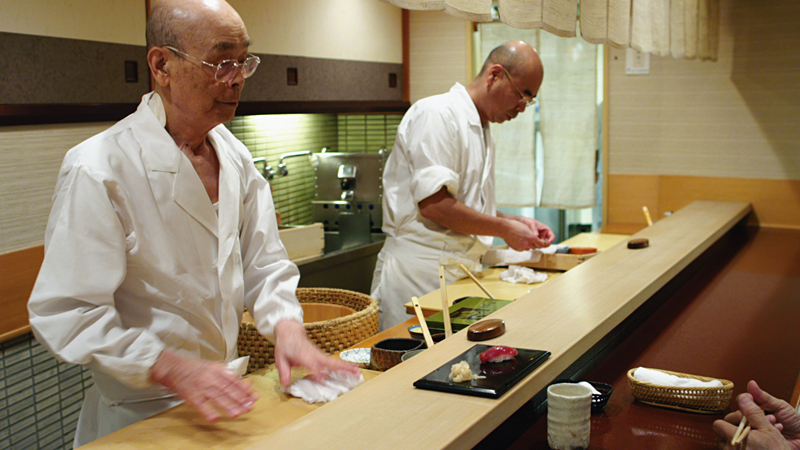Jiro (left) with son Yoshikazu at the carving counter.