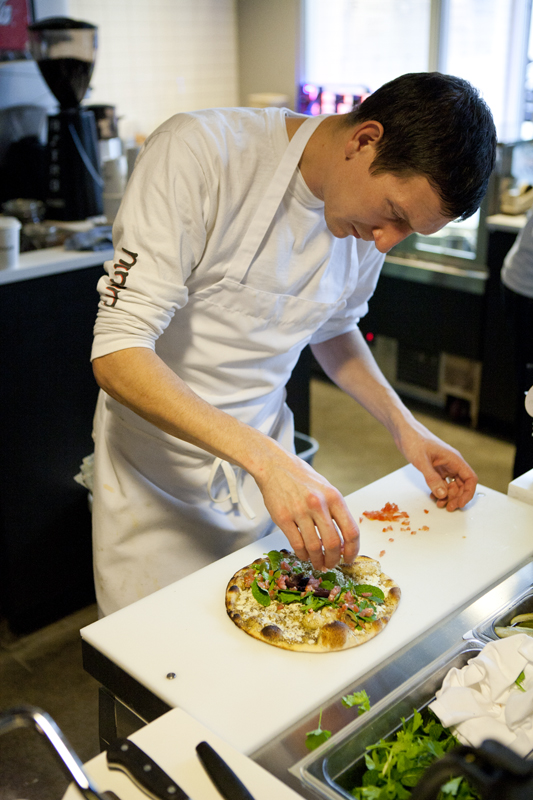 Cook Zack Chamberlain puts the final touches on the Ma'noushe jibneh wi za'atar.