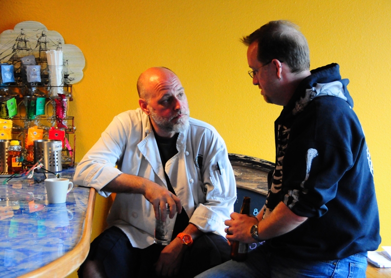 Shooting survivor and cafe chef Leonard Meuse (left) talks with Jim, a Cafe Racer regular.