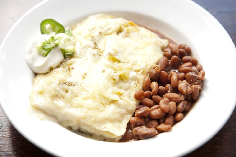 The stacked green enchiladas are so good! The creamy enchiladas, baked in a casserole until its peaks burnish, are as comforting and undemanding as an old friend's hug. Each serving's a tumble of sweet chiles, green onions and coarse tortillas, topped with a mellow Jack cheese.