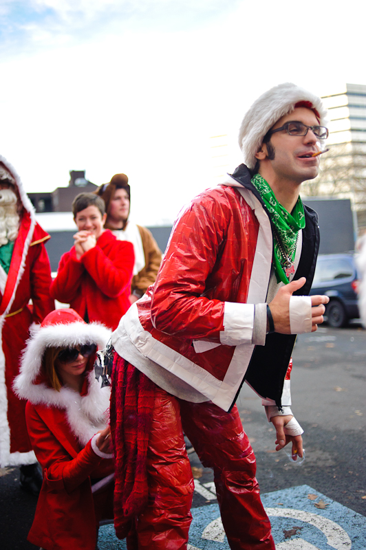 Some final adjustments are being made to this smokin' Santa's outfit.