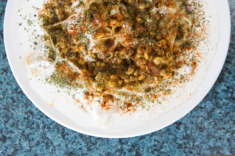 Mantoo Pasta filled with ground beef, onion and spices topped with meat sauce, garlic yogurt, and dried mint.