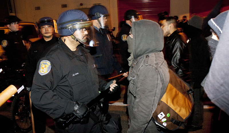 An angry protester faces an officer holding the police line by the Capitol Hill police precinct.The protestor repeatedly hurled insults and challenged the officer to hurt him.