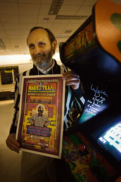 Watler Day, founder of Twin Galaxies and referee to video game record breakers in front of Make Trax, which he holds the scoring record for.