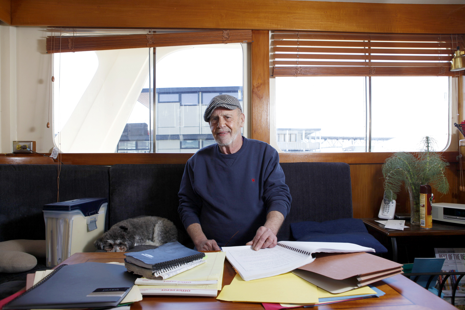 Paul Henderson revisits his case files alongside his dog Holly in his houseboat.